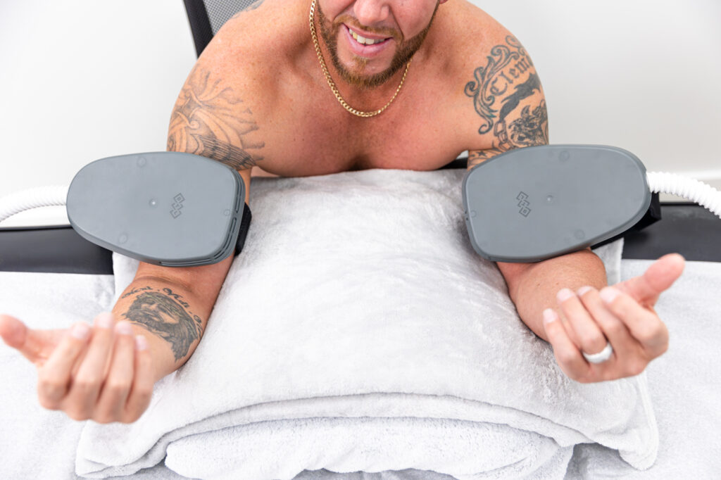 A client receives Emsculpt NEO treatment on his upper arms for noninvasive fat removal in Winter Garden.