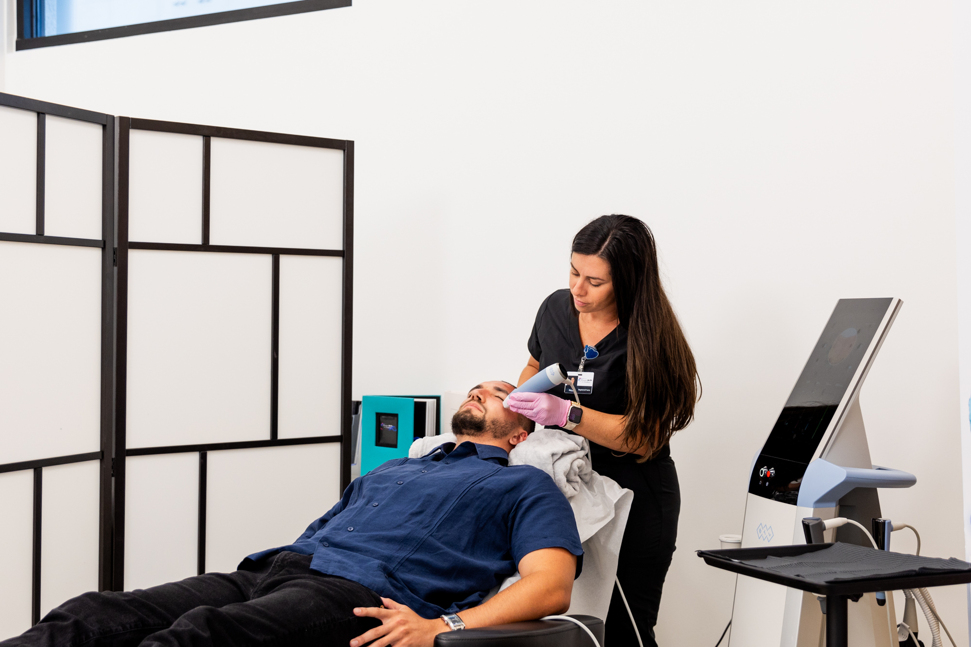 A skin specialist in Winter Garden performing a skin rejuvenation treatment on a male patient.