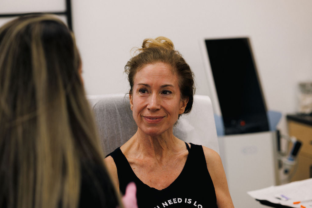 Woman smiling and listening to her gynecologist explain the benefits of estrogen replacement therapy in Winter Garden.