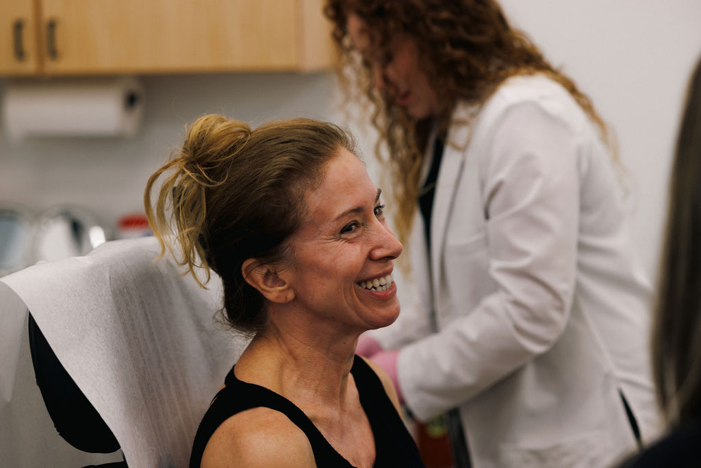 Female patient sitting in a treatment room ready for her appointment with a gynecologist in Winter Garden.